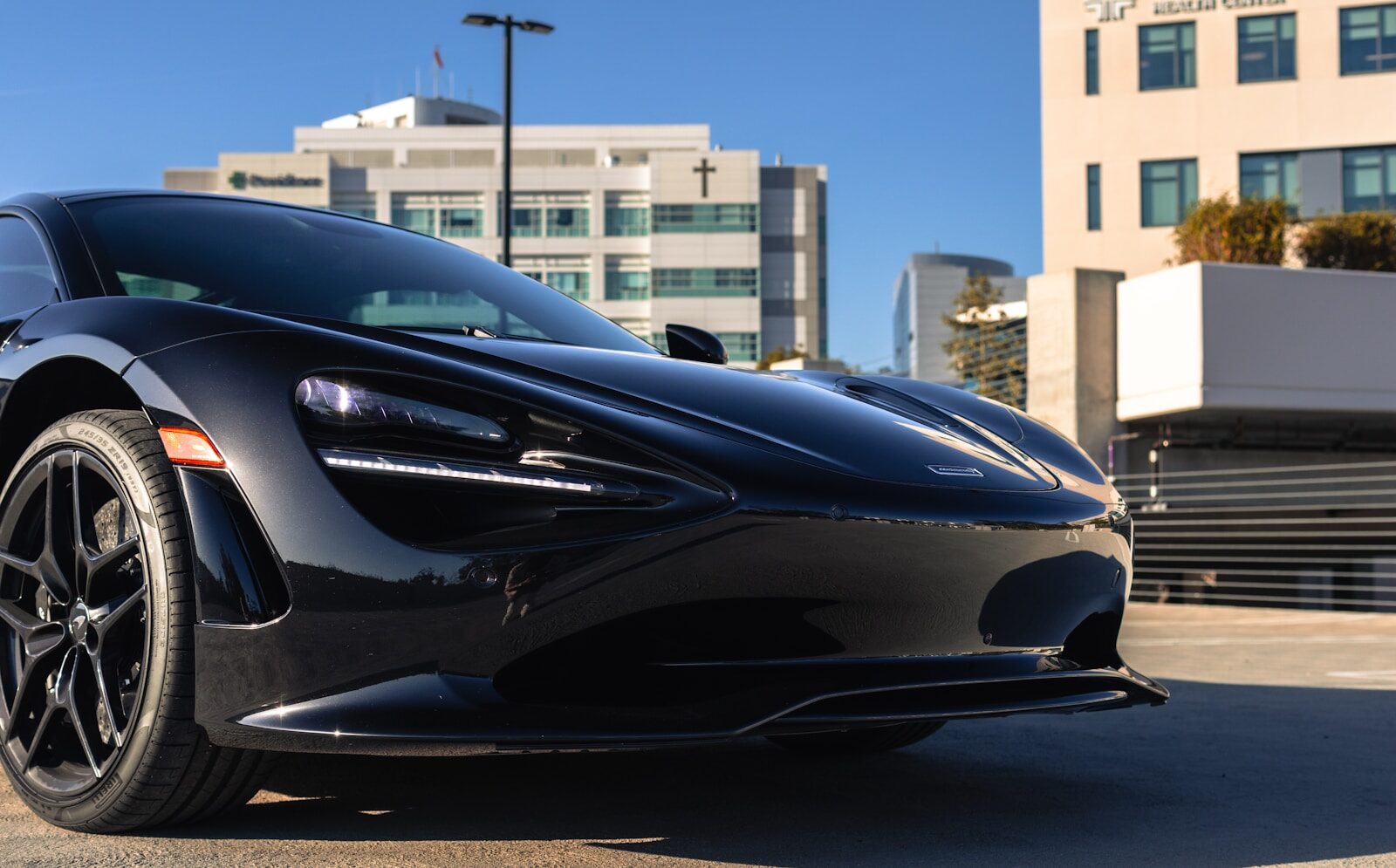 A sleek black sports car parked outdoors.